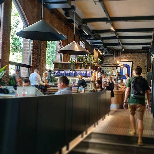 Stockroom Cafe interior with exposed brick, timber tables and afternoon light